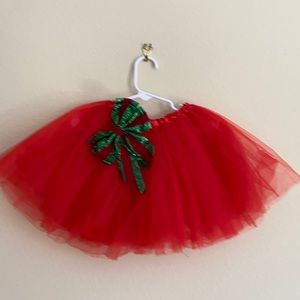 Red tulle tutu with detachable Christmas bow.
